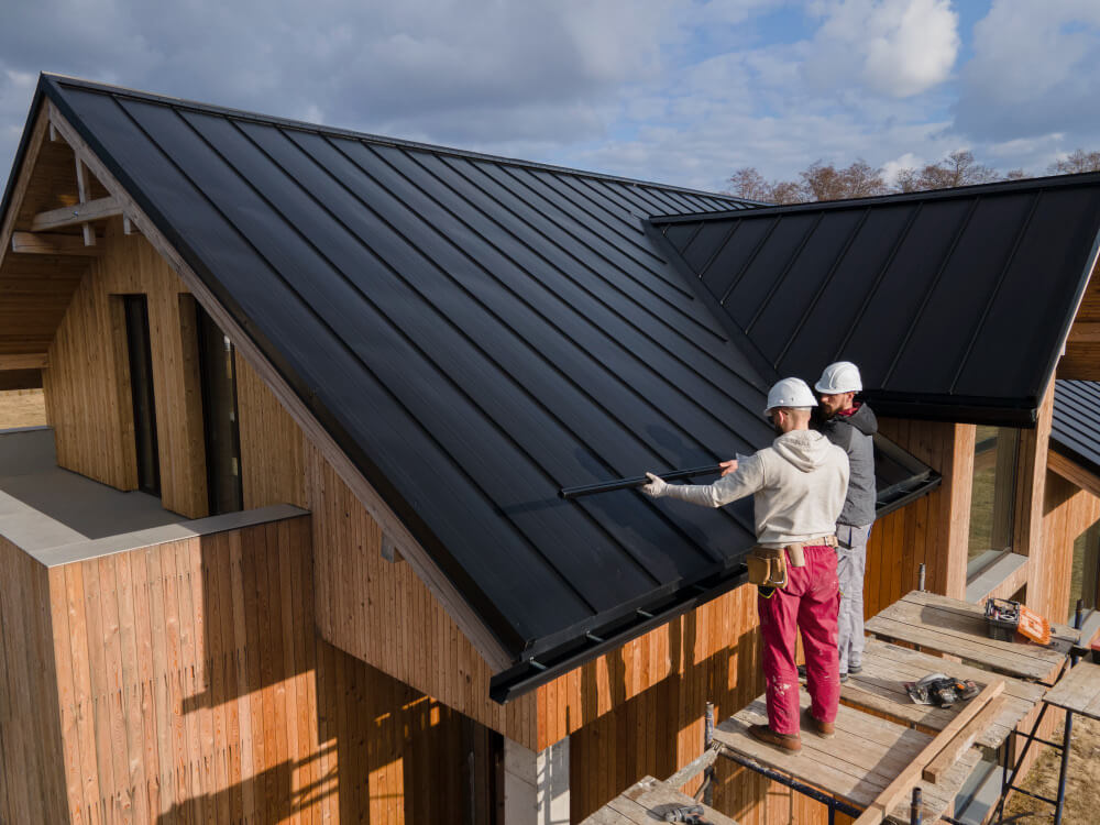 Professional roofers inspecting a new roof installation in Tynemouth